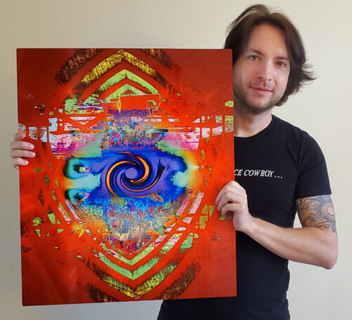 Perplexia artist Ethan J Hulbert holding Portal Cathedral as a metal print.