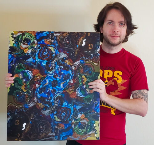 Perplexia artist Ethan J Hulbert holding Waste Trash Dump on a canvas print.